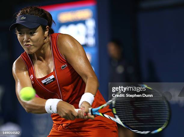 Yung-Jan Chan of Taipei hits a shot to Marion Bartoli of France in their semifinal match during day eight of the Mercury Insurance Open Presented By...