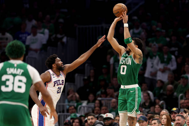 Jayson Tatum of the Boston Celtics shoots the ball against Joel Embiid of the Philadelphia 76ers during the fourth quarter in game seven of the 2023...