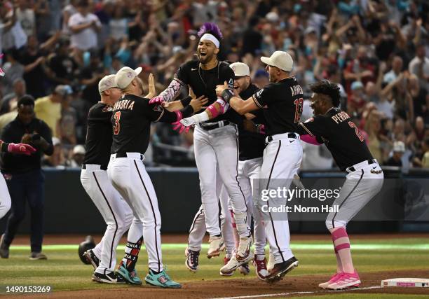 Lourdes Gurriel Jr of the Arizona Diamondbacks celebrates with teammates after hitting an RBI double in the ninth inning to beat the San Francisco...