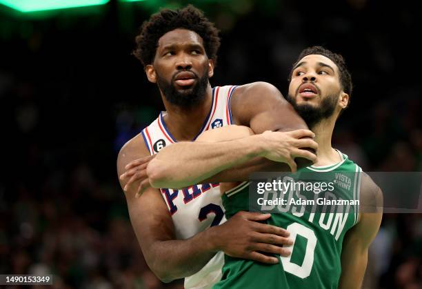 Jayson Tatum of the Boston Celtics collides with Joel Embiid of the Philadelphia 76ers during the fourth quarter in game seven of the 2023 NBA...