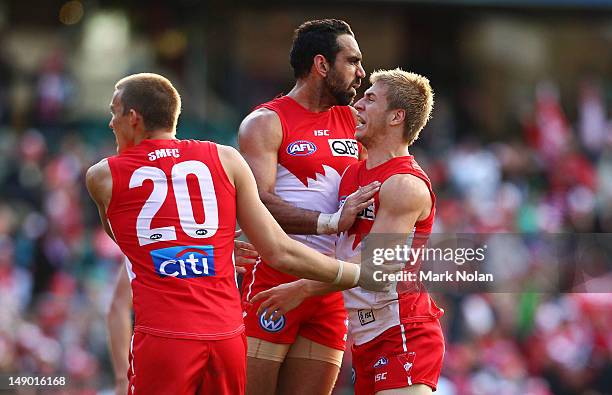 Sam Reid, Adam Goodes and Kieren Jack of the Swans celebrate goal by Jack during the round 17 AFL match between the Sydney Swans and the St Kilda...