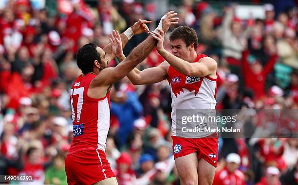 Craig Bird of the Swans celebrates kicking a goal with team mate Adam Goodes during the round 17 AFL match between the Sydney Swans and the St Kilda...