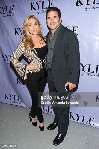 Television personality Adrienne Maloof and her husband Dr. Paul Nassif arrive at the grand opening of Kyle Richards' new boutique "Kyle By Alene Too"...