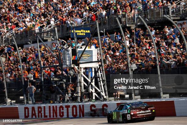 William Byron, driver of the Axalta Throwback Chevrolet, crosses the finish line to win the NASCAR Cup Series Goodyear 400 at Darlington Raceway on...