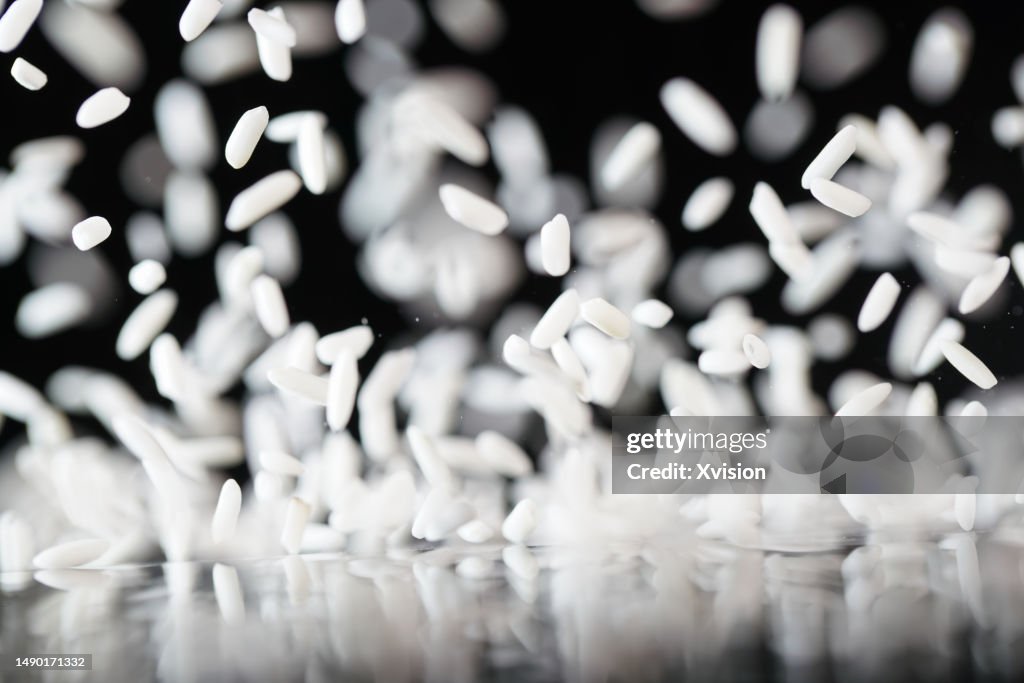 White Sticky Rice Flying In Mid Air In Black Background High-Res Stock ...