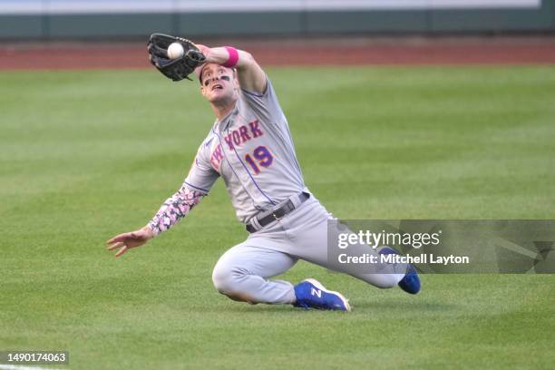 Mark Canha of the New York Mets slides to catch a fly hit by Dominic Smith of the Washington Nationals in the eight inning during game two of a...