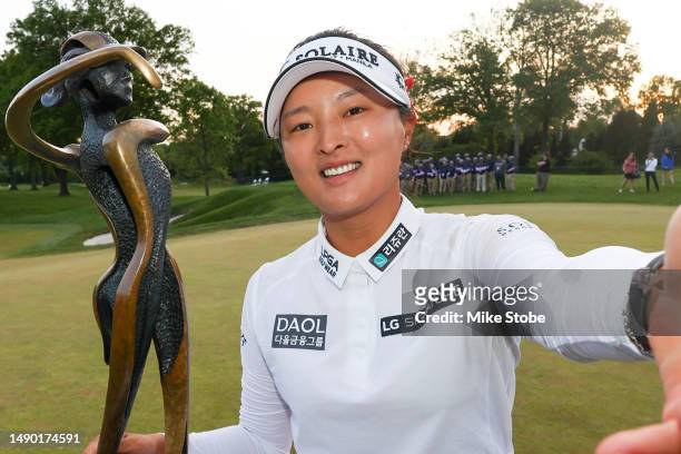 Jin Young Ko of South Korea imitates a selfie as she poses with the winners trophy after a playoff win against Minjee Lee of Australia during the...