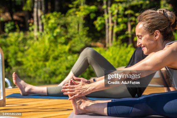 women doing yoga. - stretching hamstring stock pictures, royalty-free photos & images