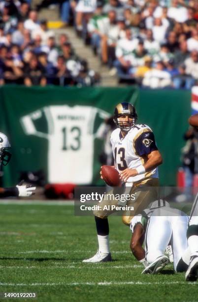 Quarterback Kurt Warner of the St. Louis Rams drops back to pass the ball in the game between the St. Louis Rams vs the New York Jets at The...