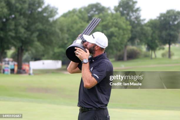 Dustin Johnson of Aces GC kisses the Individual Championship trophy after winning LIV Golf - Tulsa during Day Three of the LIV Golf Invitational -...