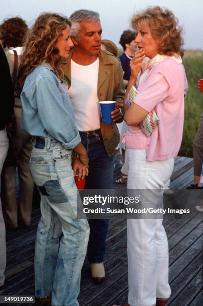 American fashion designer Ralph Lauren and his wife, therapist Ricky Lauren , speak with television journalist Barbara Walters at an outdoor party on...