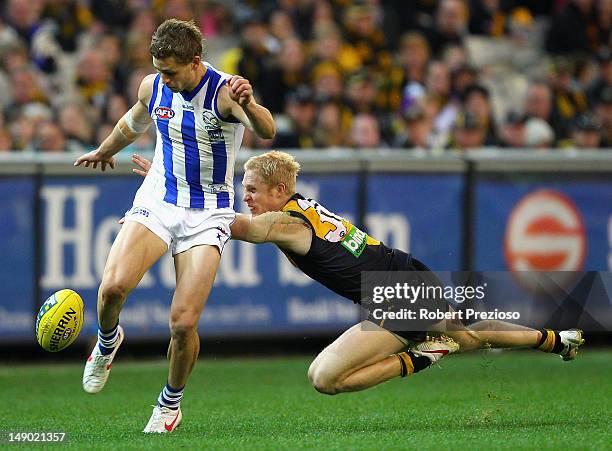 Kieran Harper of the Kangaroos kicks under pressure during the round 17 AFL match between the Richmond Tigers and the North Melbourne Kangaroos at...