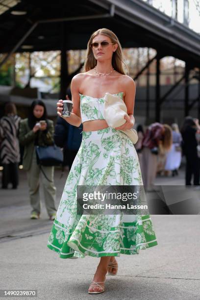 Jordan Simek wearing Leo Lin crop top and maxi skirt, Parde sunglasses and Zara clutch at Afterpay Australian Fashion Week 2023 at Carriageworks on...