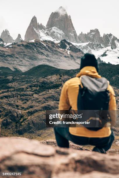 man resting on the rock in el chalten - chalten stock pictures, royalty-free photos & images