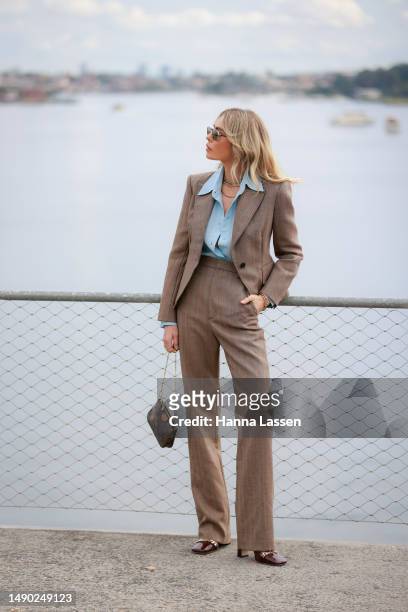 Emily Gurr wearing Scanlan Theodore suite and Louis Vuitton clutch at Afterpay Australian Fashion Week 2023 at Carriageworks on May 15, 2023 in...