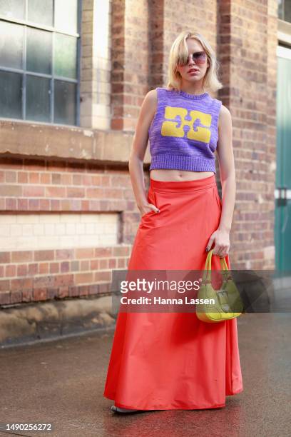 Violet Grace Atkinson wearing purple vest, yellow Prada purse, red maxi skirt and baby blue Miu Miu shoes at Afterpay Australian Fashion Week 2023 at...