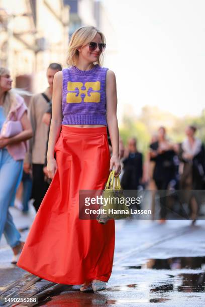 Violet Grace Atkinson wearing purple vest, yellow Prada purse, red maxi skirt and baby blue Miu Miu shoes at Afterpay Australian Fashion Week 2023 at...