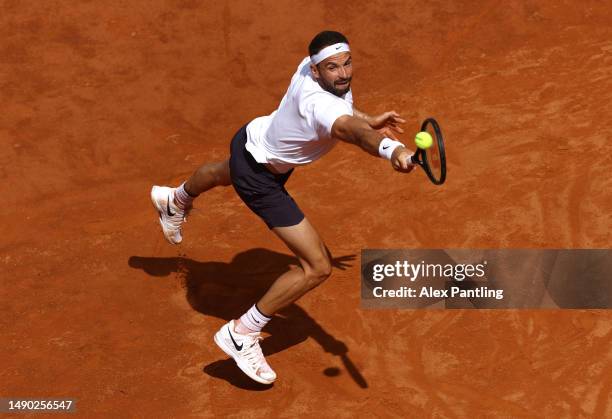 Grigor Dimitrov of Bulgaria plays a backhand during the Men's Singles Round of 32 match against Novak Djokovic of Serbia during Day Seven of the...