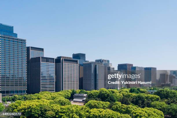 the skyline of central tokyo in fresh green - townscape stock pictures, royalty-free photos & images