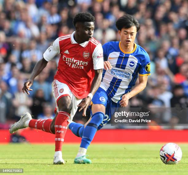 Bukayo Saka of Arsenal takes on Kaoru Mitoma of Brighton during the Premier League match between Arsenal FC and Brighton & Hove Albion at Emirates...