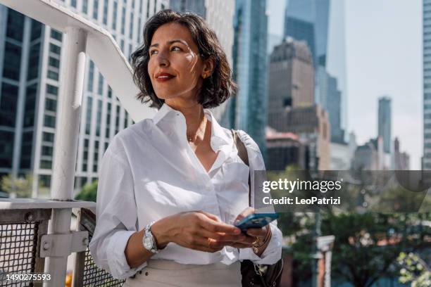 business woman on break texting on mobile out of the office - businesswoman nyc stock pictures, royalty-free photos & images