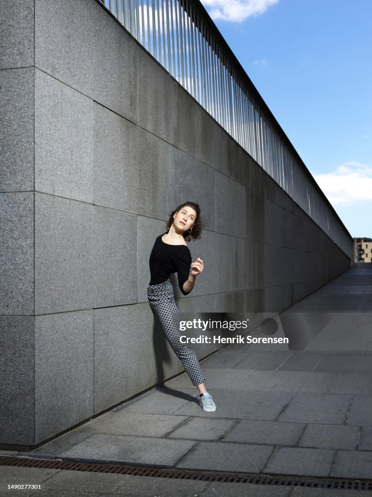 Young woman stuck in a wall