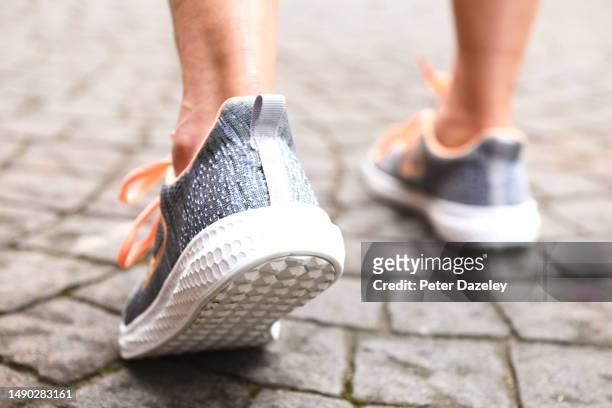 seniopr woman running - senior women jogging stock pictures, royalty-free photos & images