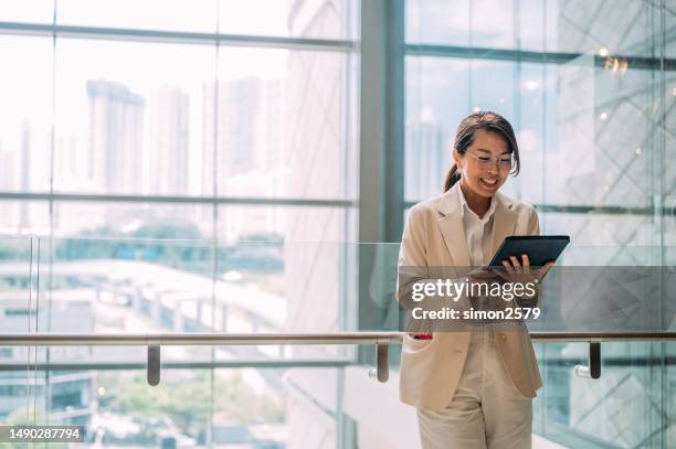 from start-up to empire: the journey of an asian female entrepreneur in e-commerce - business person on tablet stock pictures, royalty-free photos & images