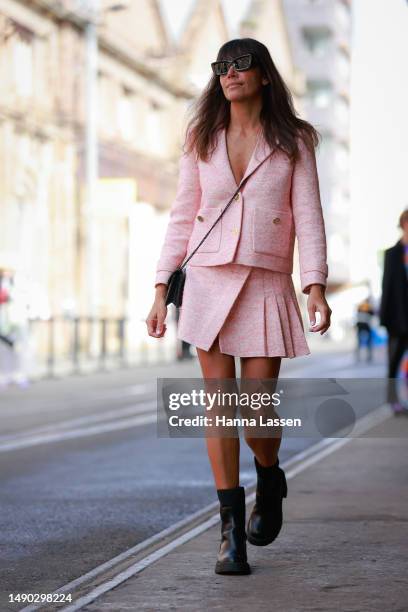 Nicole Adolphe wearing Maje pink blazer and mini skirt, YSL bag and Prada sunnies at Afterpay Australian Fashion Week 2023 at Carriageworks on May...