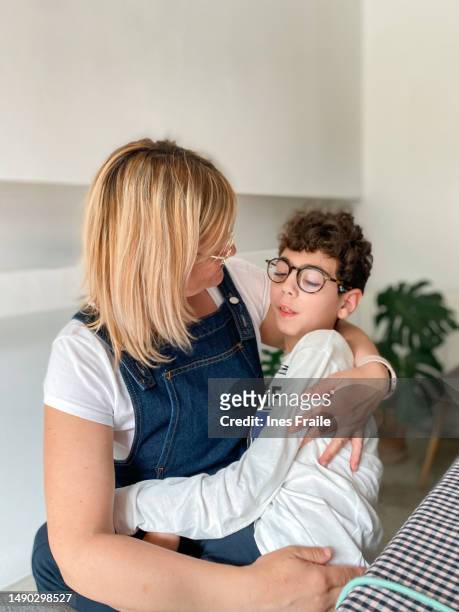 loving mother with disabled son sitting on top - ass stockfoto's en -beelden