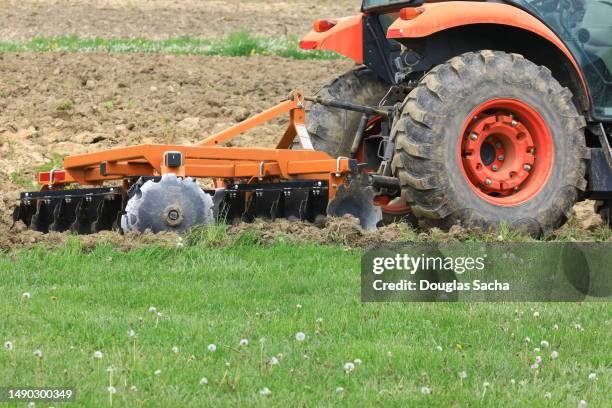 tractor with disk harrow attachment for tilling the soil - harrow agricultural equipment stock pictures, royalty-free photos & images