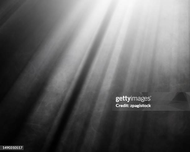 light rays illuminating white smoke against black background - calque photos et images de collection