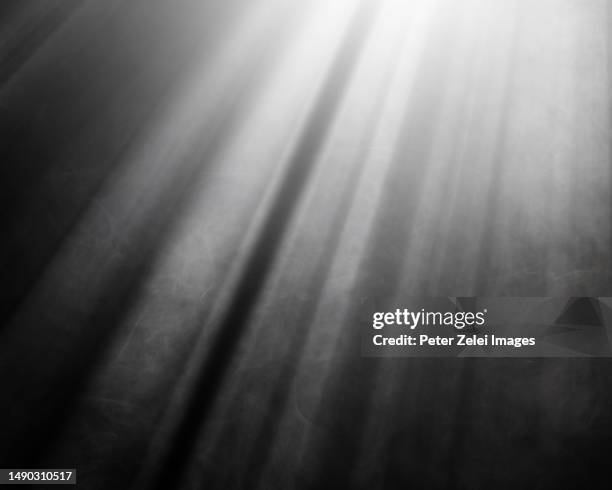 light rays illuminating white smoke against black background - sunbeam ストックフォトと画像