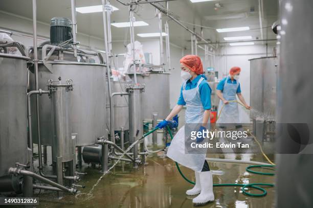 factory worker cleaning flooring factory interior storage tank section filtering machine and tanks after production completed - industrial cleaning stock pictures, royalty-free photos & images