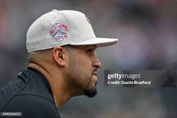 Antonio Senzatela of the Colorado Rockies looks on from the dugout as he wears a hat recognizing Mothers Day and breast cancer awareness during a...