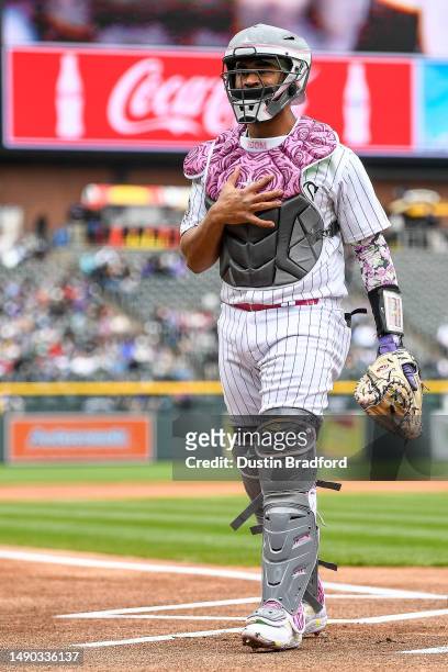 Elias Diaz of the Colorado Rockies warms up before catching the first inning of a game against the Philadelphia Phillies at Coors Field on May 14,...