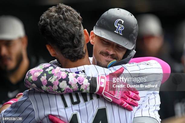 Brenton Doyle of the Colorado Rockies celebrates with Ezequiel Tovar in the dugout after hitting a fifth inning solo homerun in a game against the...