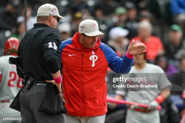 Umpire Ryan Wills has a word with Rob Thomson of the Philadelphia Phillies in the sixth ininng of a game against the Colorado Rockies at Coors Field...