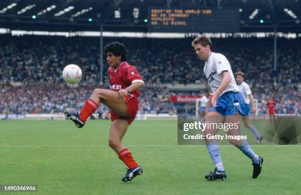 Argentina player Diego Maradona in action under the eye of Chris Waddle during a Football League XI v Rest Of World friendly match at Wembley Stadium...