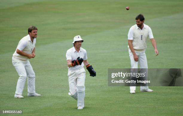 England players Mike Gatting and Graham Gooch alongside wicketkeeper Bob Taylor who had been called out of retirement to keep wicket on the second...