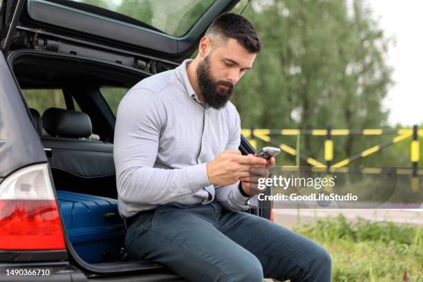 man texting - station wagon stock pictures, royalty-free photos & images