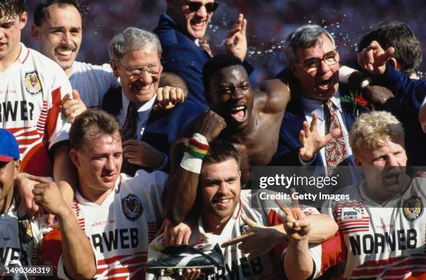 Members of the Wigan rugby league team celebrate after beating Leeds 26-16 to win the Silk Cut Challenge Cup final at Wembley Stadium, London, 30th...