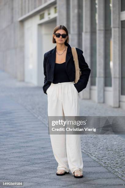 Jacqueline Zelwis wears black cropped ONWEEKENDS blazer, Zara top, creme white Mybestfriends pants, Flattered shoes & bag, Viu sunglasses on May 15,...