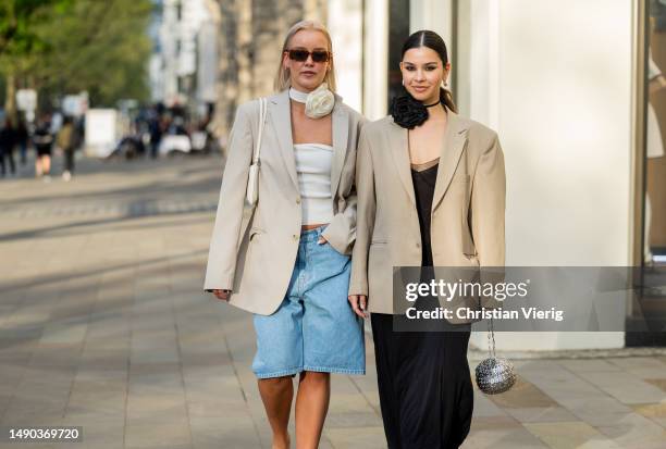 Tina Haase wears Carhartt baggy Bermuda shorts, vintage oversized beige blazer, flower choker, Jacquemus Bisou Baguette Bag, vintage Guido Sgariglia...