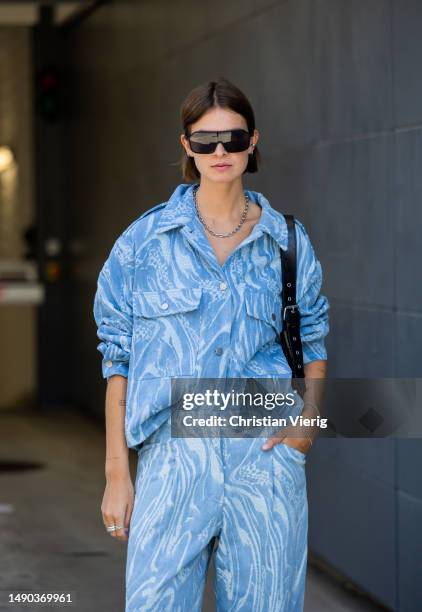Jacqueline Zelwis wears blue Lala Berlin jeans & jacket, Adidas sneakers, black Nunoo bag, Calvin Klein Jeans sunglasses, necklace on May 15, 2023 in...