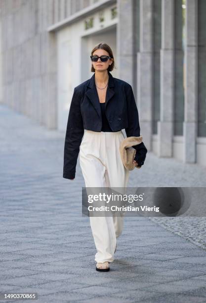 Jacqueline Zelwis wears black cropped ONWEEKENDS blazer, Zara top, creme white Mybestfriends pants, Flattered shoes & bag, Viu sunglasses on May 15,...