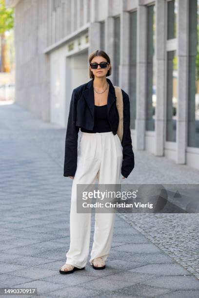 Jacqueline Zelwis wears black cropped ONWEEKENDS blazer, Zara top, creme white Mybestfriends pants, Flattered shoes & bag, Viu sunglasses on May 15,...