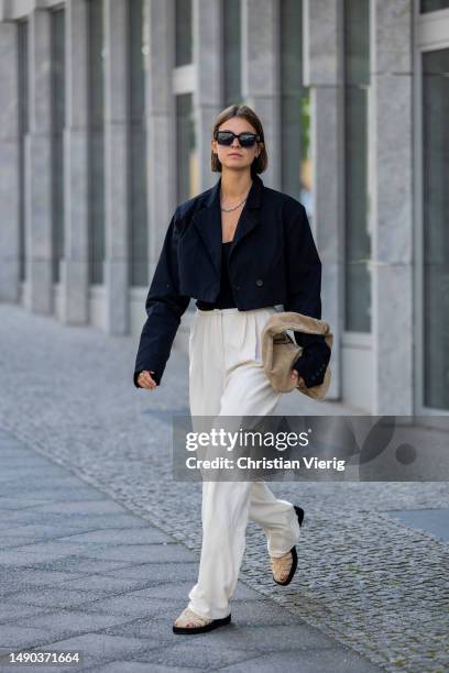 Jacqueline Zelwis wears black cropped ONWEEKENDS blazer, Zara top, creme white Mybestfriends pants, Flattered shoes & bag, Viu sunglasses on May 15,...