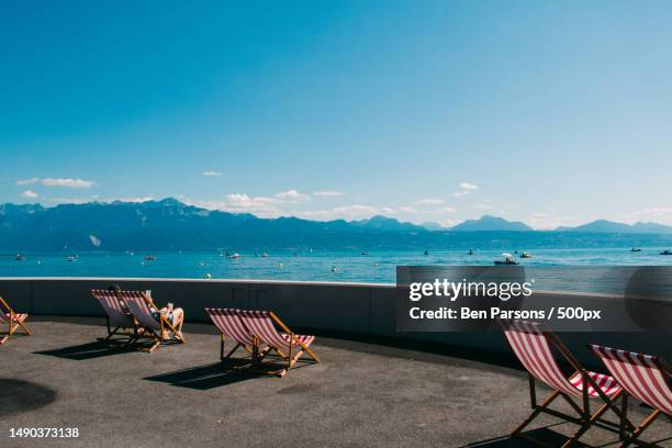 empty chairs and tables at beach against sky,lausanne,switzerland - lausanne stock pictures, royalty-free photos & images