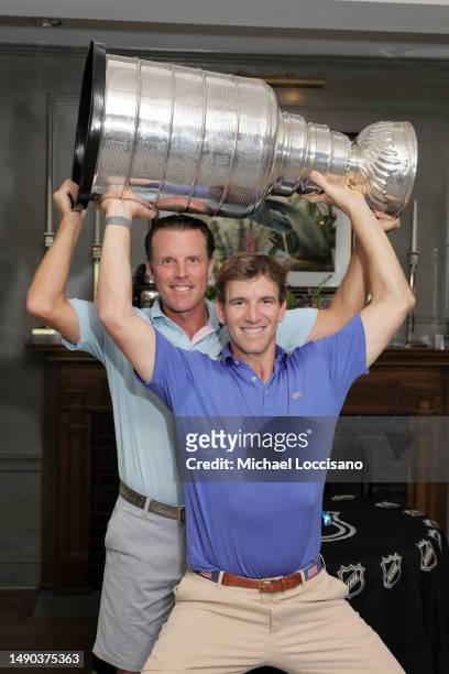 Brad Richards and Eli Manning with the Stanley Cup during the 2023 NHL Stanley Cup Tour at Somerset Hills Country Club on May 12, 2023 in...